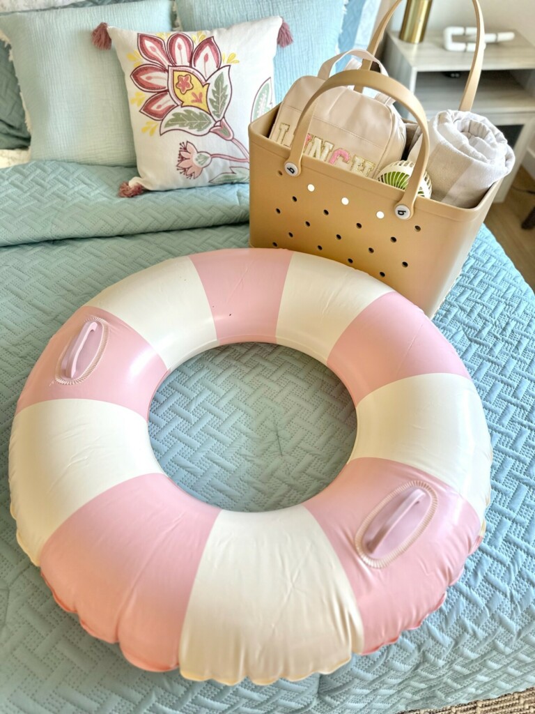 pink and white striped inflatable pool float, beach vacation packing list for family, beach vacation essentials, packing for beach vacation checklist, list of what to pack for a beach vacation, beach essentials for baby, beach accessories, what to bring to the beach, must haves for a beach vacation